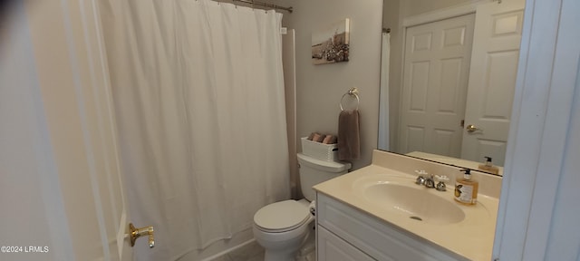 bathroom with vanity, curtained shower, and toilet