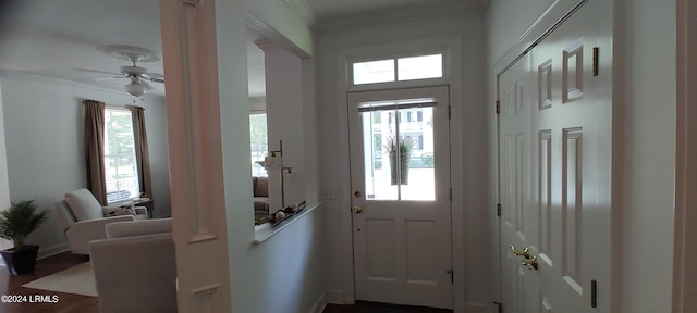 entryway with ceiling fan and ornamental molding