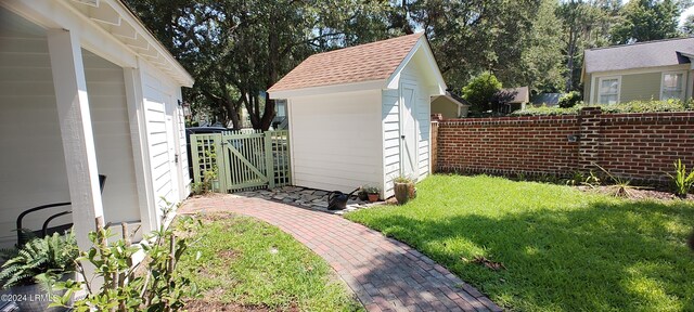 view of outbuilding featuring a lawn