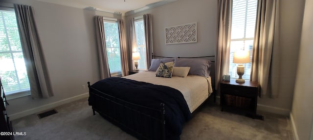 carpeted bedroom featuring ornamental molding