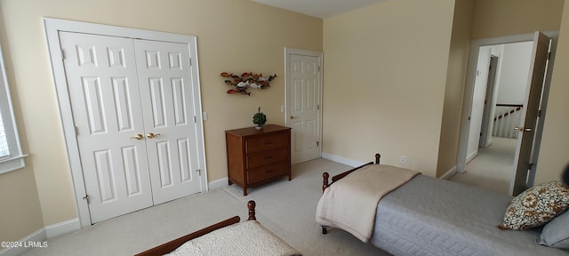 bedroom featuring light carpet and a closet