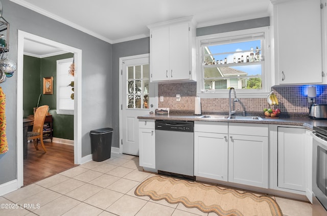 1508 London Ave, Port Royal, SC 29935 - kitchen with stainless steel appliances, dark countertops, tasteful backsplash, light tile patterned floors, and crown molding