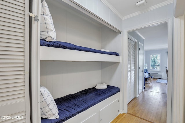 interior space with light wood-type flooring and crown molding