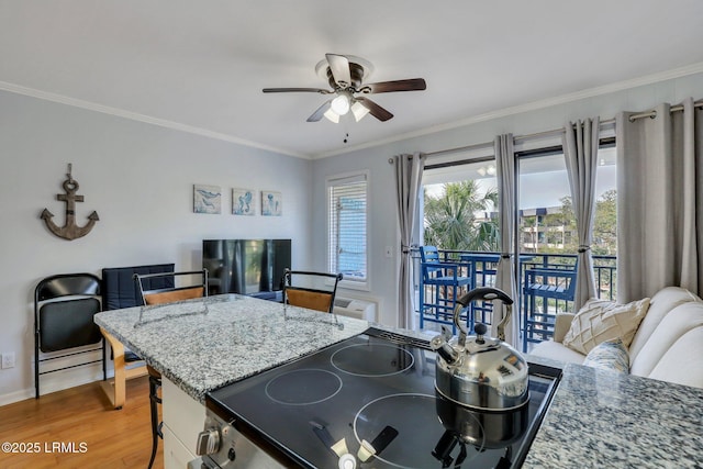 kitchen featuring range with electric cooktop, ceiling fan, light stone counters, wood finished floors, and crown molding