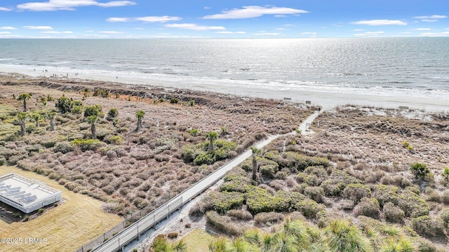 bird's eye view with a water view and a beach view