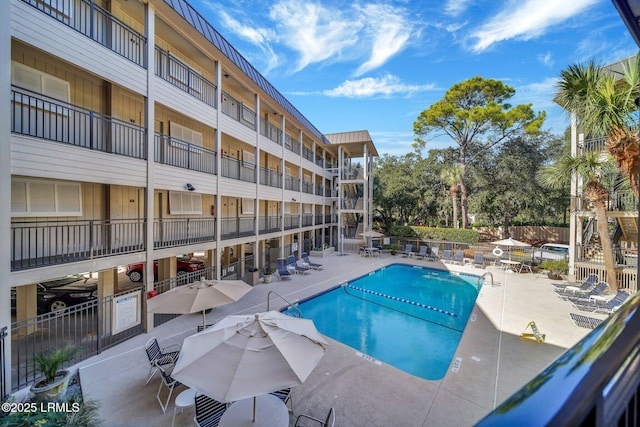 pool featuring a patio area and fence