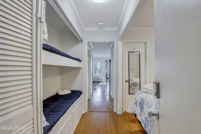 corridor featuring crown molding and hardwood / wood-style flooring