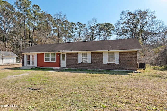 ranch-style house featuring cooling unit, a front lawn, and french doors