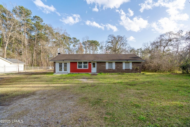 ranch-style house featuring french doors, a front yard, fence, and brick siding