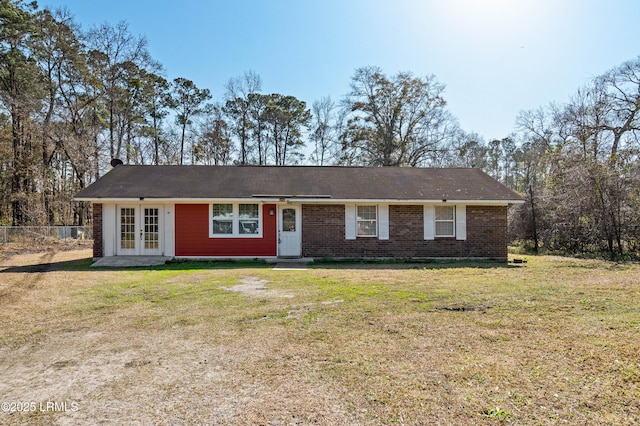 ranch-style house featuring a front lawn and french doors