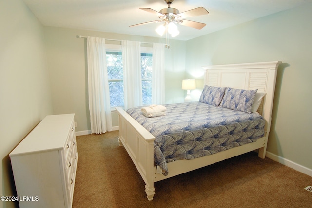carpeted bedroom featuring baseboards and ceiling fan