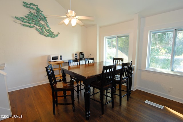 dining space featuring wood finished floors, a ceiling fan, and baseboards