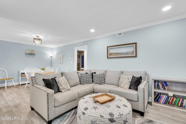 living room featuring ornamental molding and light wood-type flooring