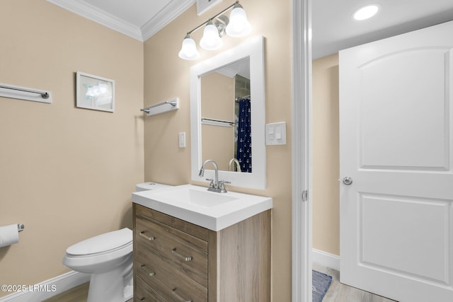 bathroom featuring ornamental molding, toilet, wood-type flooring, and vanity