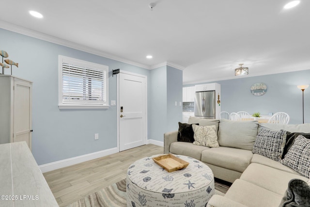 living room featuring ornamental molding and light wood-type flooring