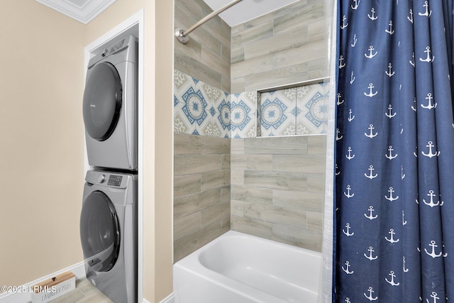 bathroom with stacked washer / dryer, ornamental molding, and shower / bath combination with curtain