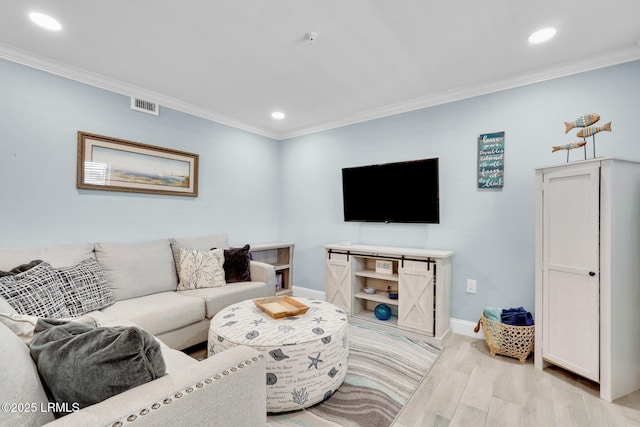 living room with ornamental molding and light wood-type flooring