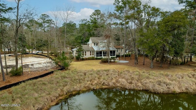 exterior space with a water view and a lawn