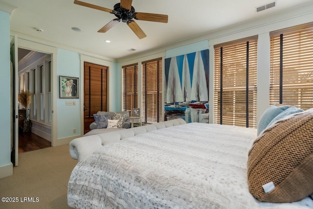 bedroom with a closet, visible vents, carpet flooring, ceiling fan, and baseboards