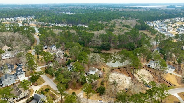 birds eye view of property featuring a residential view and a forest view