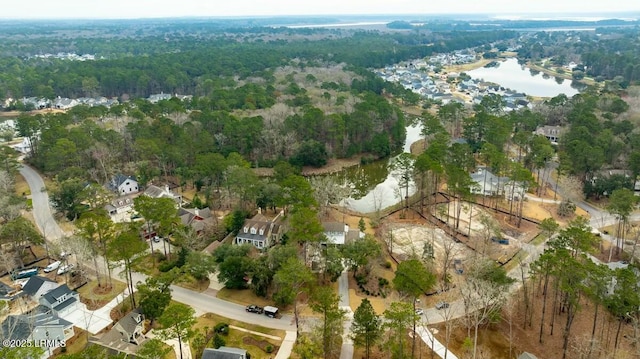 drone / aerial view featuring a water view and a wooded view