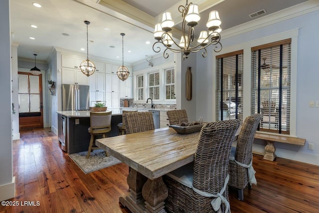 dining room featuring a chandelier, recessed lighting, visible vents, ornamental molding, and dark wood finished floors