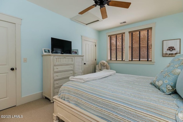 bedroom with attic access, baseboards, visible vents, a ceiling fan, and light colored carpet