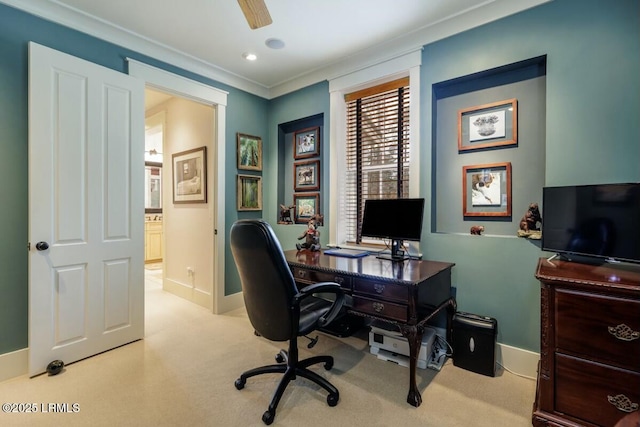 office with ornamental molding, light carpet, baseboards, and a ceiling fan