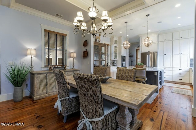 dining area featuring visible vents, a chandelier, and dark wood-style flooring