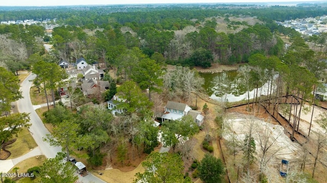 drone / aerial view with a wooded view