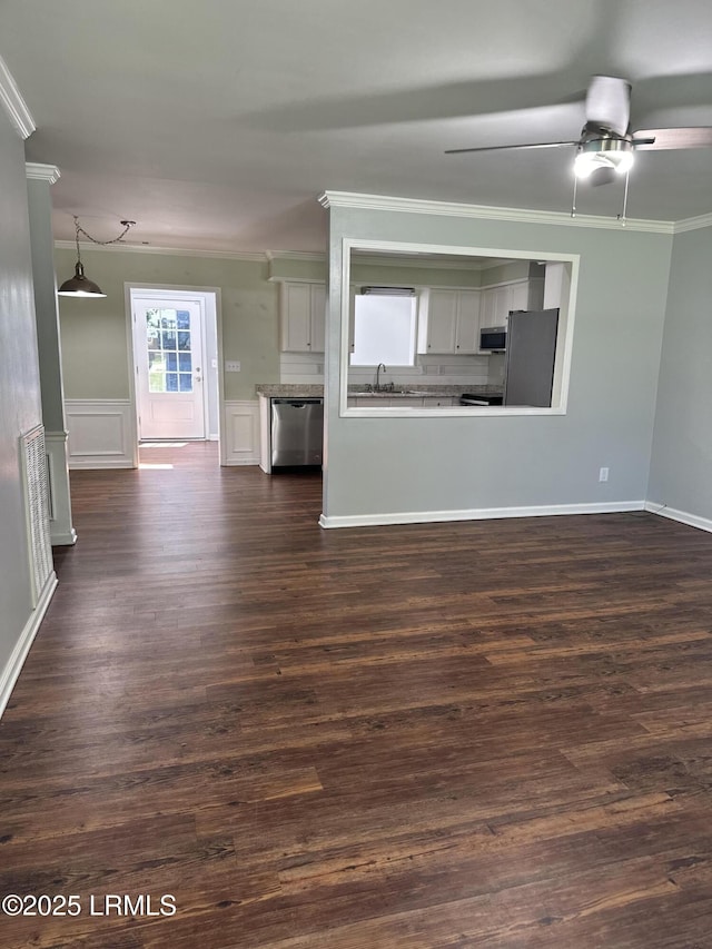 14007 Kader St, Beaufort, SC 29906 - unfurnished living room with ornamental molding, a ceiling fan, and dark wood-type flooring
