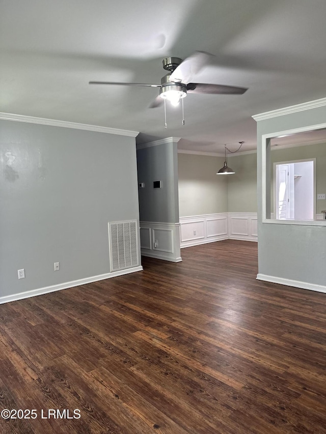 14007 Kader St, Beaufort, SC 29906 - empty room featuring crown molding, a ceiling fan, wainscoting, dark wood finished floors, and a decorative wall