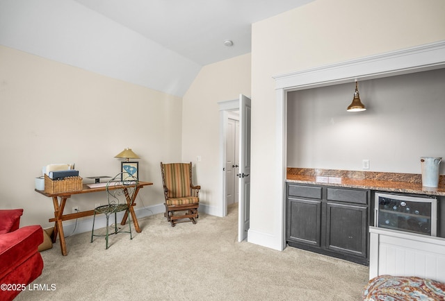 sitting room with light colored carpet, baseboards, and lofted ceiling