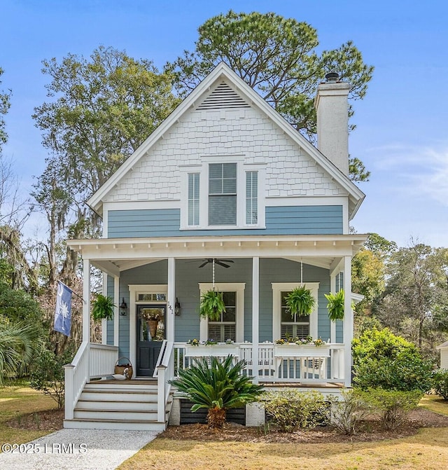 bungalow featuring covered porch and a chimney