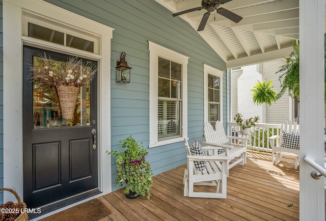 wooden deck featuring a ceiling fan and covered porch