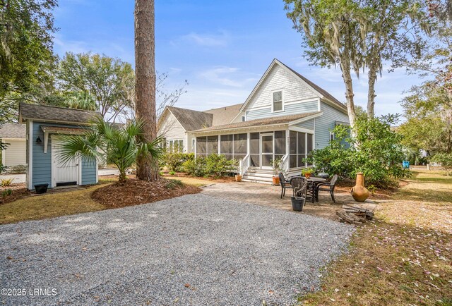 view of front facade featuring a patio and a sunroom