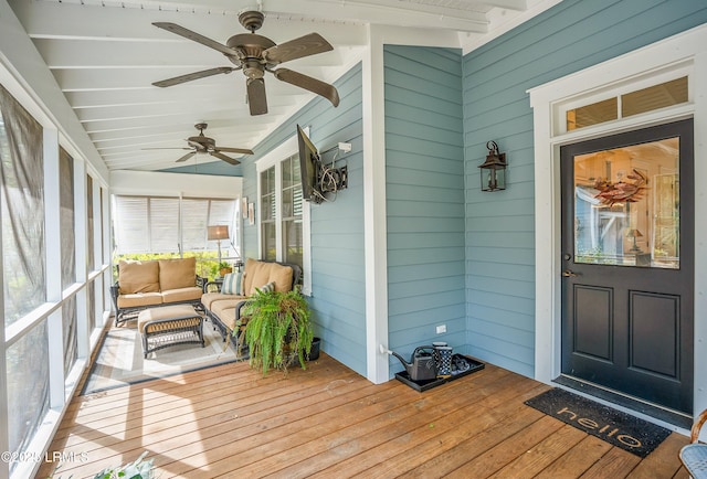 sunroom featuring lofted ceiling with beams