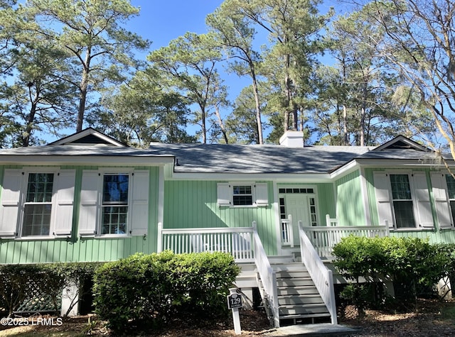 view of front of property with a porch and a chimney