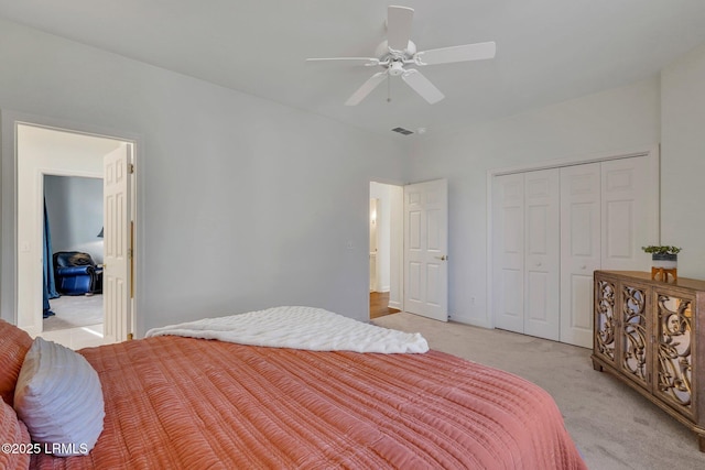 carpeted bedroom featuring ceiling fan and a closet