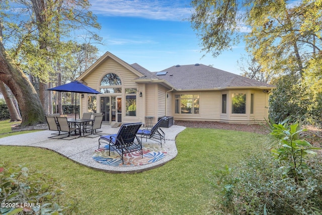 rear view of house with a yard and a patio area