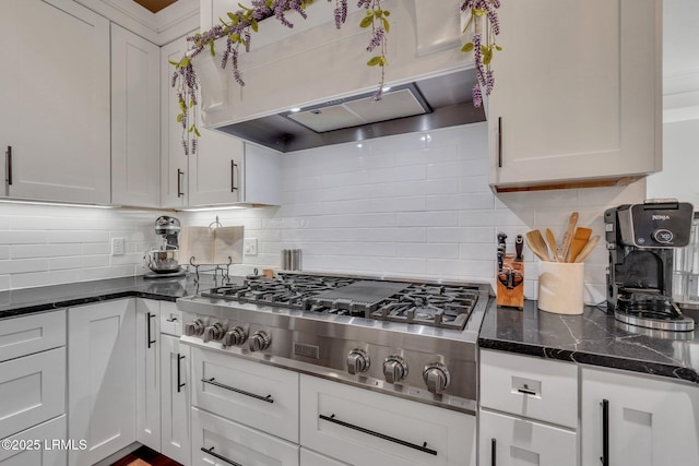 kitchen featuring white cabinets, decorative backsplash, and stainless steel gas stovetop