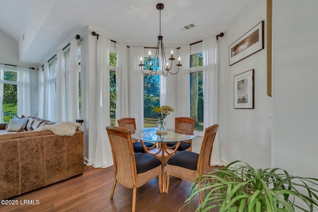 dining room with wood-type flooring and a chandelier