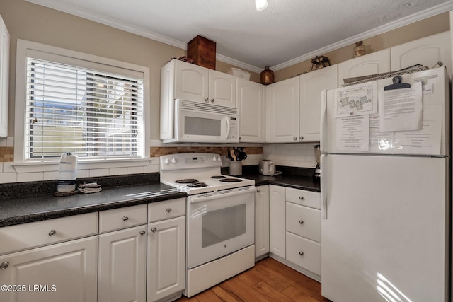 kitchen featuring white cabinetry, backsplash, white appliances, and ornamental molding