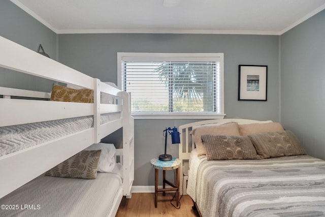 bedroom featuring crown molding and hardwood / wood-style floors