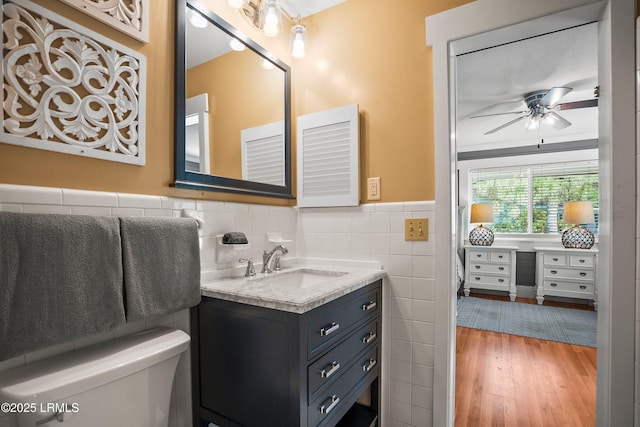 738 Marlin Dr, Fripp Island, SC 29920 - bathroom with toilet, vanity, a ceiling fan, tile walls, and wood finished floors
