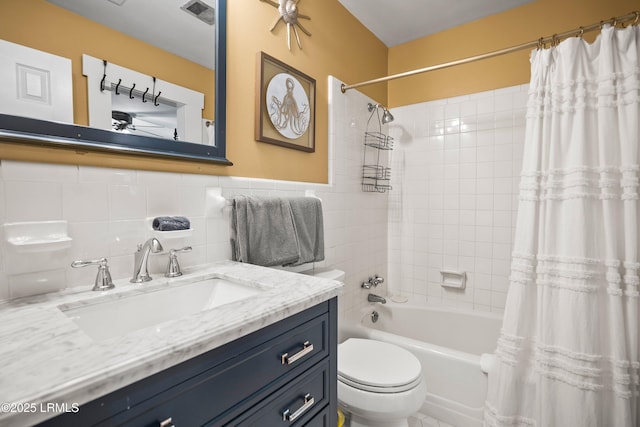 738 Marlin Dr, Fripp Island, SC 29920 - bathroom featuring shower / bath combo, toilet, vanity, and tile walls