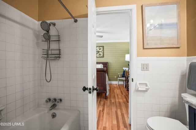 738 Marlin Dr, Fripp Island, SC 29920 - full bath with tile walls, washtub / shower combination, wood finished floors, toilet, and wainscoting
