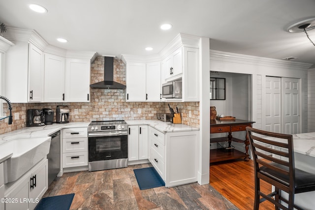 738 Marlin Dr, Fripp Island, SC 29920 - kitchen featuring wall chimney exhaust hood, stainless steel appliances, white cabinetry, light stone countertops, and tasteful backsplash