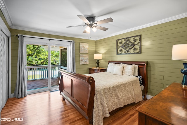 738 Marlin Dr, Fripp Island, SC 29920 - bedroom with access to outside, wood finished floors, crown molding, ceiling fan, and wooden walls