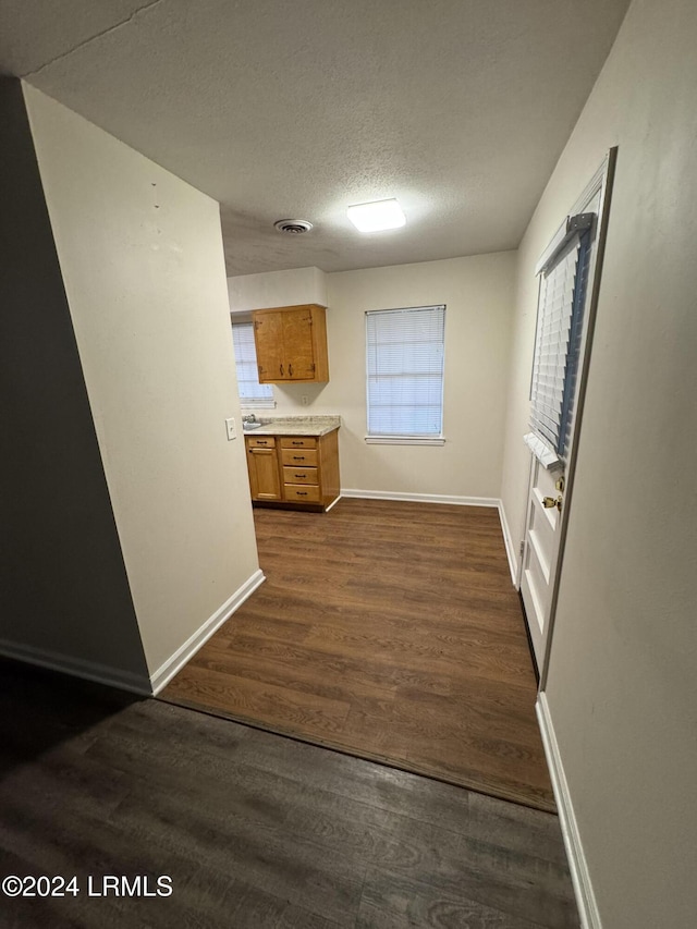 kitchen featuring dark hardwood / wood-style floors and a textured ceiling